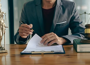 Lawyer reviewing legal documents - Aminu Law Firm, PLLC